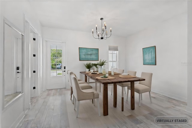 dining room with a chandelier and light hardwood / wood-style flooring