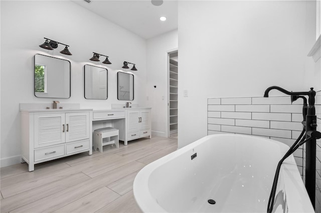 bathroom with vanity and a bathtub