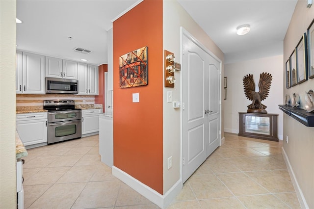 hallway with light tile patterned floors