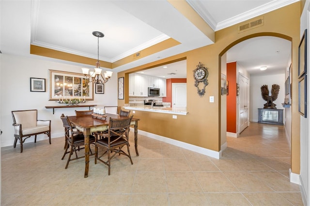 tiled dining area featuring crown molding, a chandelier, a tray ceiling, and sink