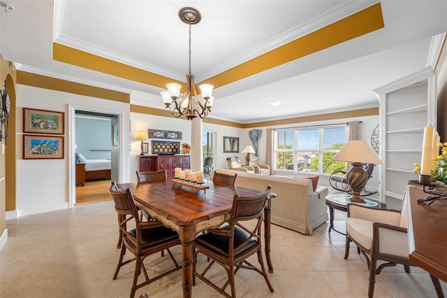 dining room with crown molding, a notable chandelier, and light tile patterned flooring