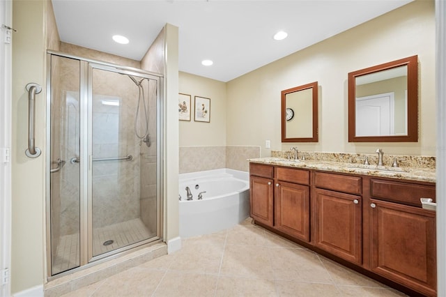 bathroom featuring plus walk in shower, tile patterned flooring, and vanity