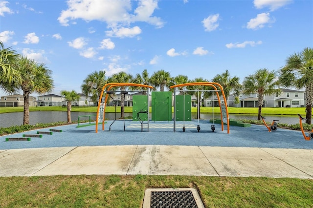 view of play area featuring a yard and a water view