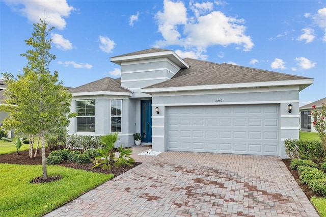 view of front of property featuring a garage and a front yard