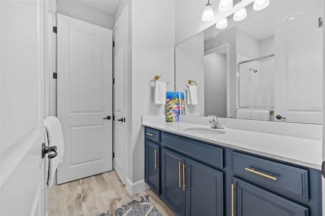 bathroom featuring vanity, a shower, and hardwood / wood-style flooring