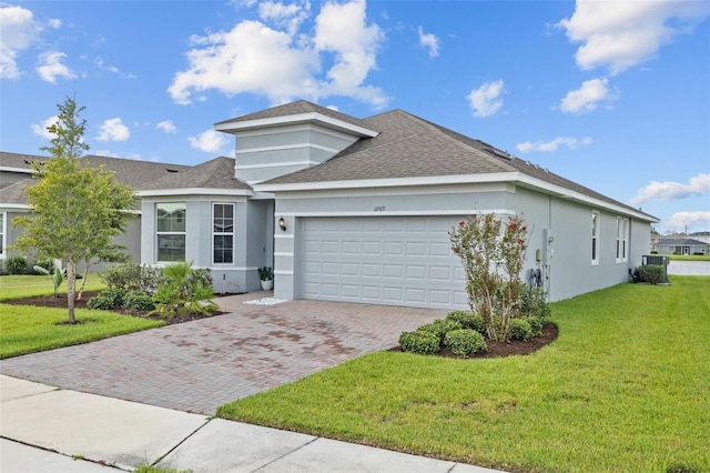 view of front of home featuring a garage and a front yard