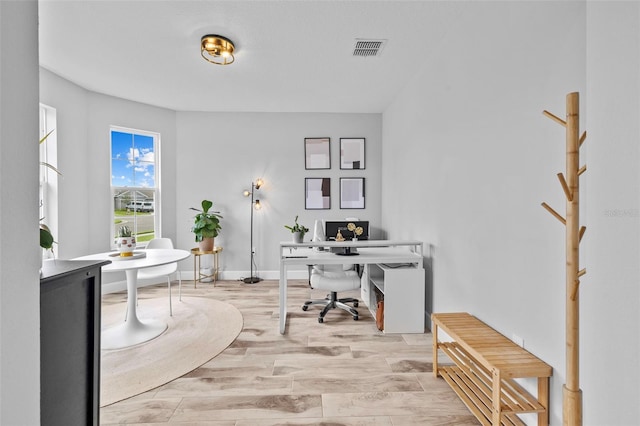 office with light hardwood / wood-style flooring