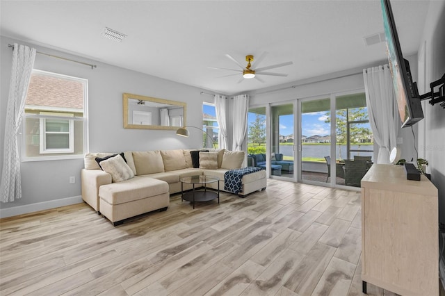 living room featuring ceiling fan and light hardwood / wood-style floors