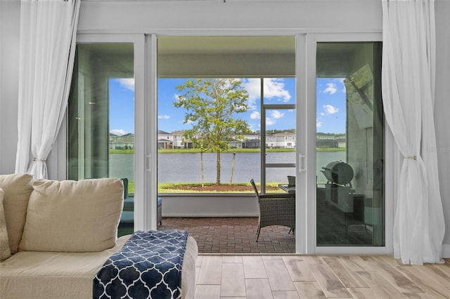 sunroom / solarium featuring a water view