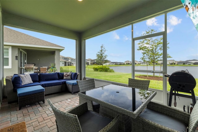 sunroom featuring a water view and a wealth of natural light