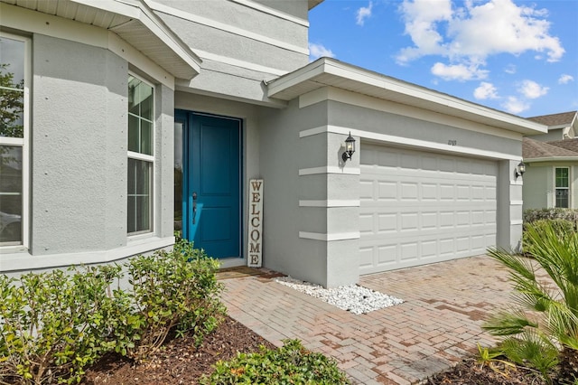 view of exterior entry with a garage