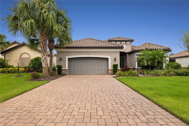 mediterranean / spanish-style house with a front yard and a garage