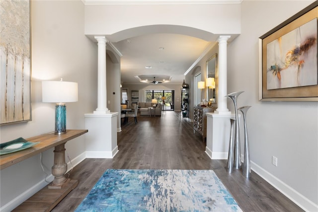 foyer featuring ornamental molding, ornate columns, and dark hardwood / wood-style floors