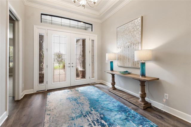 foyer with ornamental molding, french doors, and dark hardwood / wood-style floors