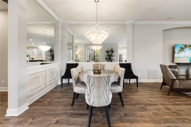 dining space featuring crown molding, dark wood-type flooring, and an inviting chandelier