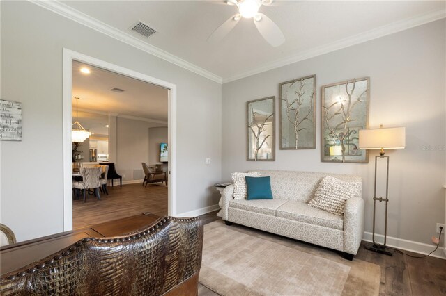 living room featuring ornamental molding, hardwood / wood-style flooring, and ceiling fan