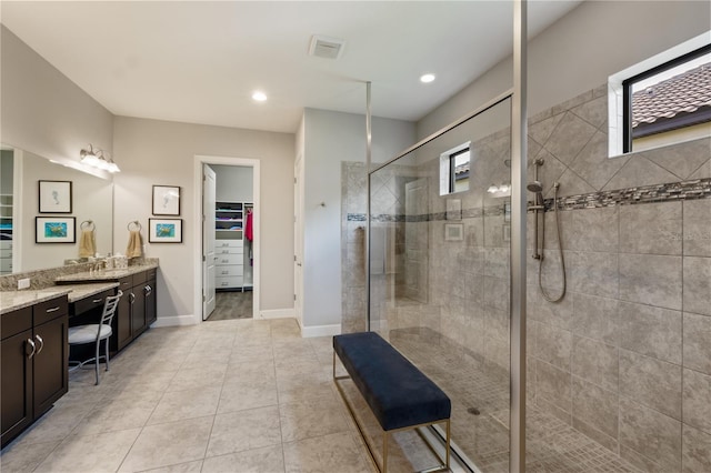 bathroom with vanity, tile patterned floors, and a shower with door