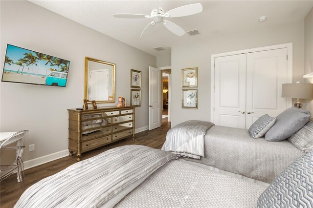 bedroom with a closet, ceiling fan, and dark hardwood / wood-style floors