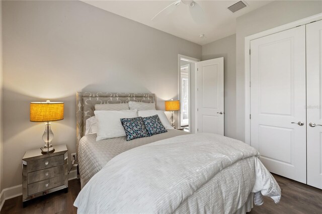 bedroom with a closet, ceiling fan, and dark hardwood / wood-style floors