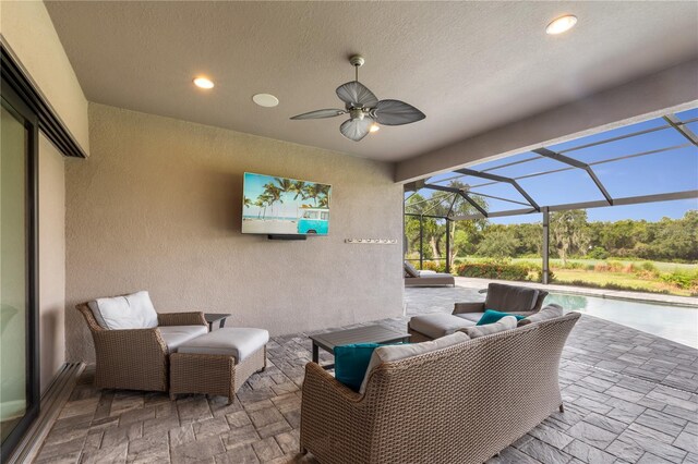 view of patio featuring ceiling fan, an outdoor hangout area, and a lanai