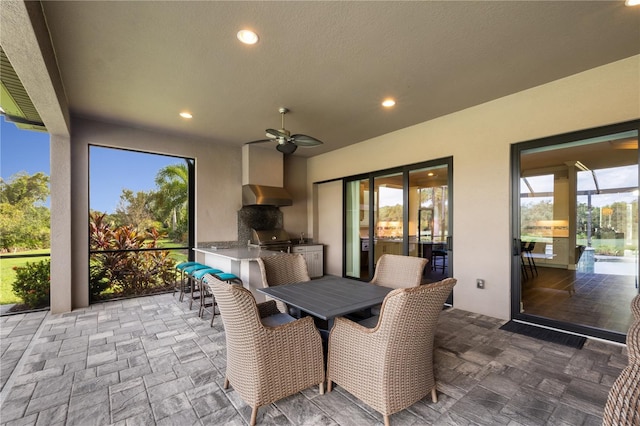 sunroom with a wealth of natural light and ceiling fan