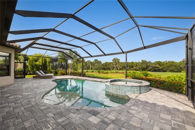 view of pool with glass enclosure, a patio area, and an in ground hot tub