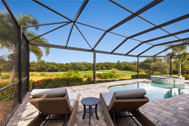 view of swimming pool featuring a lanai, an in ground hot tub, and a patio