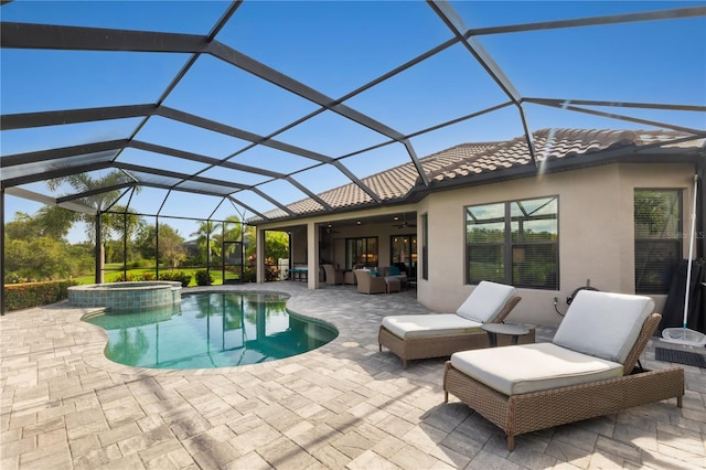 view of swimming pool featuring glass enclosure, a patio area, ceiling fan, and an in ground hot tub