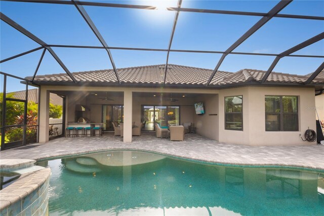 view of pool with a lanai, ceiling fan, and a patio