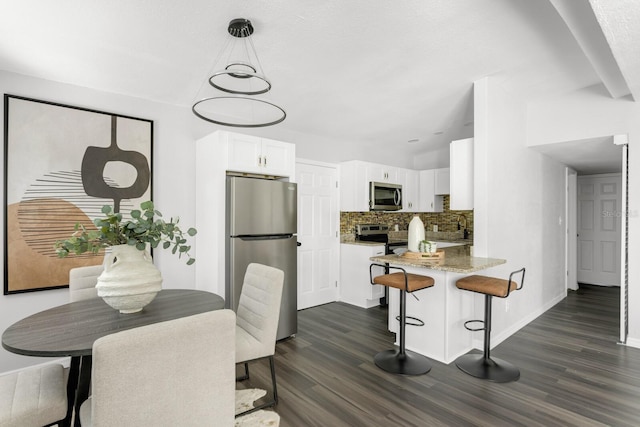 dining room with dark hardwood / wood-style floors