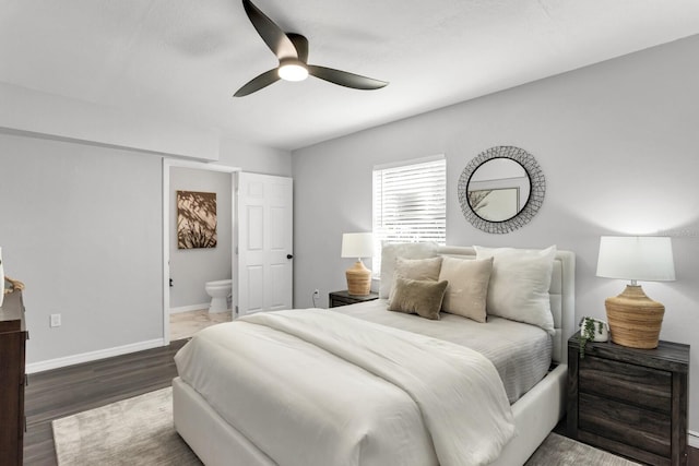 bedroom with ensuite bathroom, ceiling fan, and hardwood / wood-style flooring