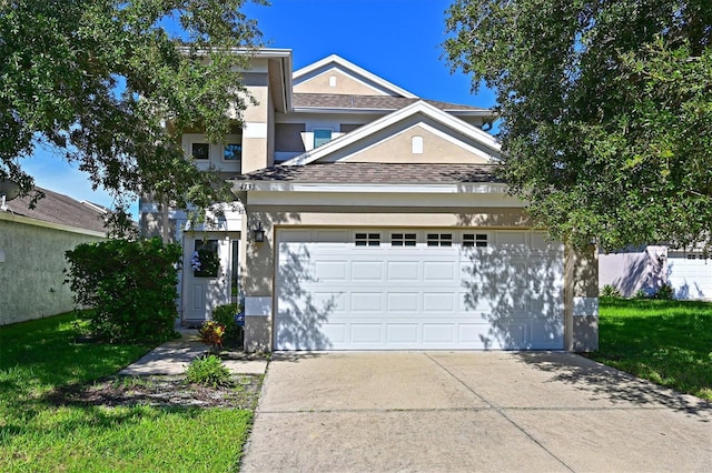 view of front of home with a garage and a front lawn