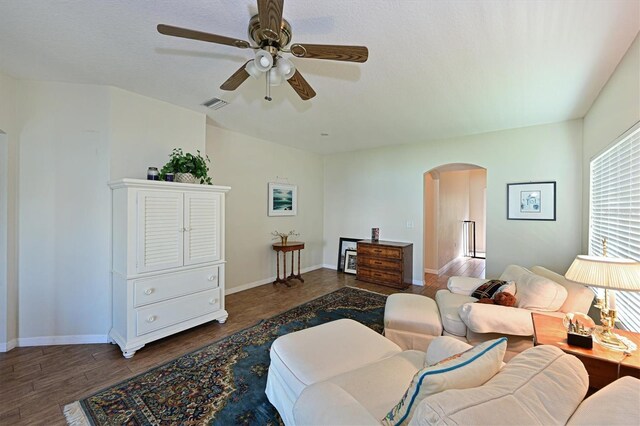 living room featuring dark hardwood / wood-style flooring and ceiling fan