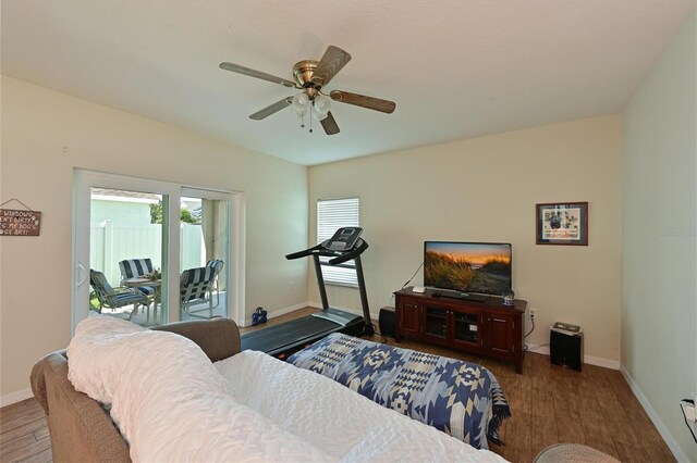 bedroom featuring access to outside, hardwood / wood-style floors, and ceiling fan