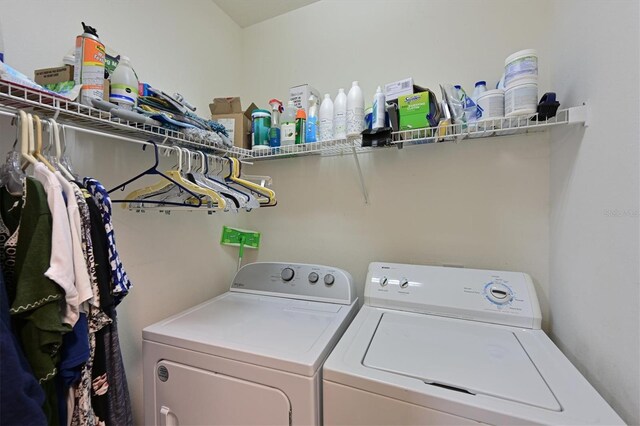 washroom with washing machine and clothes dryer