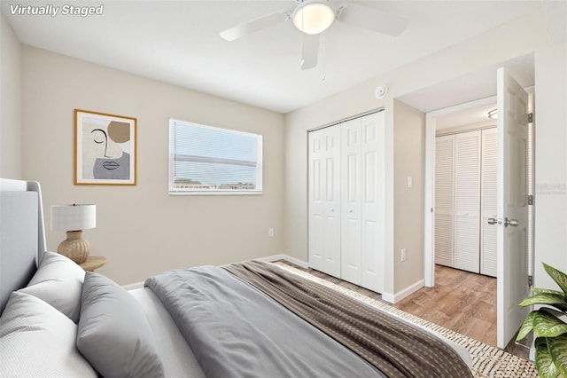 bedroom with light hardwood / wood-style flooring, ceiling fan, and a closet