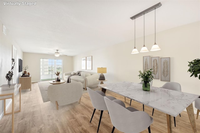 dining area featuring ceiling fan and light hardwood / wood-style flooring