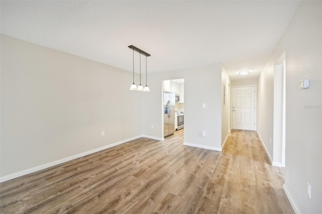 unfurnished dining area with light wood-type flooring