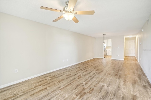 unfurnished room featuring light wood-type flooring and ceiling fan