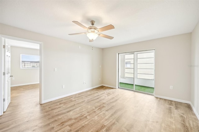 spare room with light wood-type flooring and ceiling fan