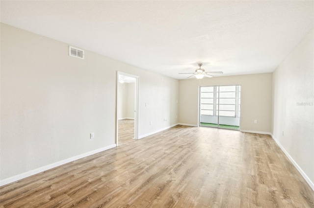 empty room with light wood-type flooring and ceiling fan