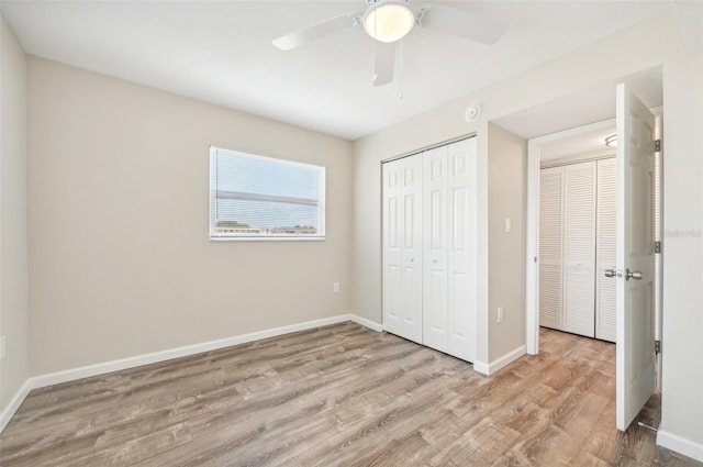 unfurnished bedroom featuring wood-type flooring and ceiling fan