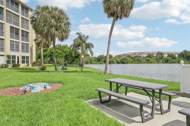 view of property's community with a yard and a water view