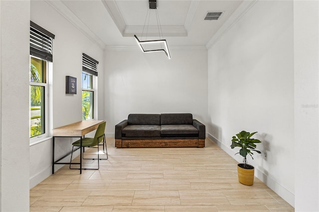 interior space with light hardwood / wood-style floors, a raised ceiling, and ornamental molding