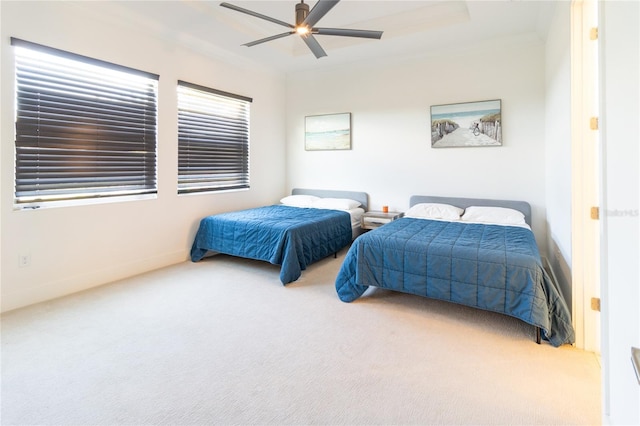 carpeted bedroom featuring ceiling fan and crown molding