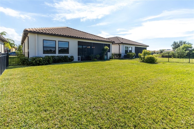 back of house featuring a lawn