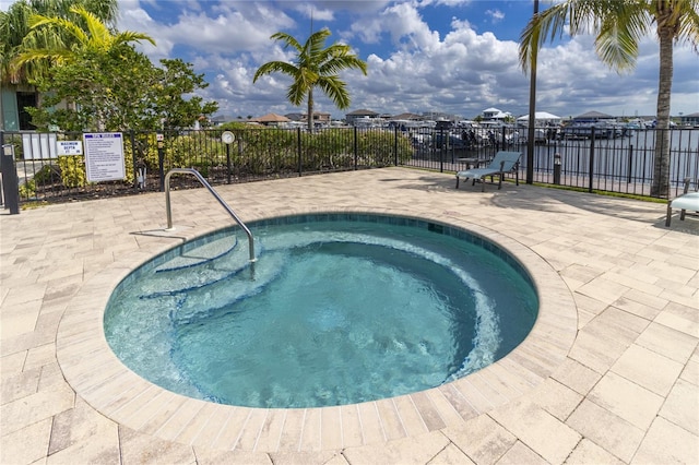 view of swimming pool with a patio and a hot tub