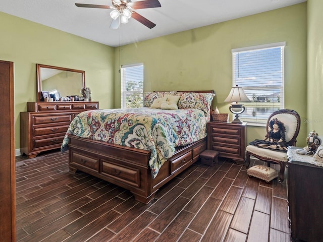 bedroom with dark hardwood / wood-style floors, multiple windows, and ceiling fan