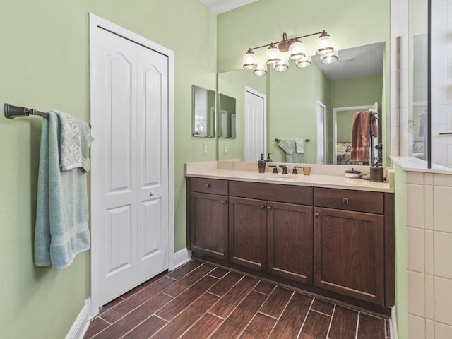 bathroom with walk in shower and vanity