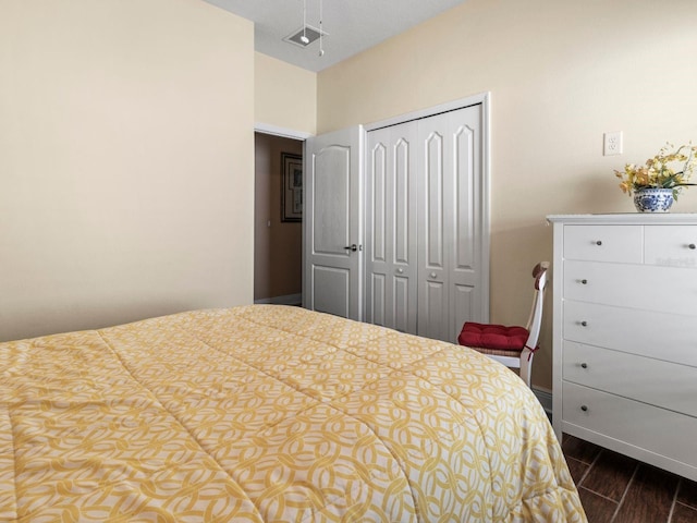 bedroom with a closet and dark hardwood / wood-style flooring